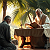 Poetry: The first image is a garden of palms where light drips like oil from fronds. Two men bend over a...